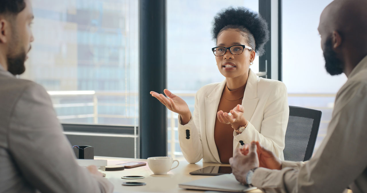 Lawyer talking with coworkers at desk